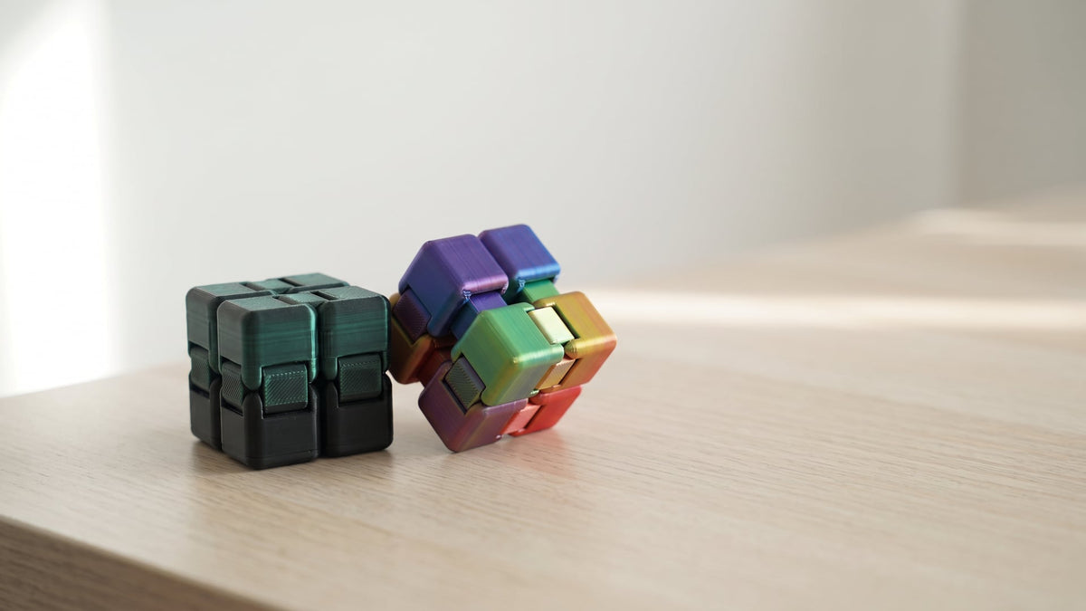 Infinity cube fidget toy, 8 cm, 3D printed from PLA, folded open on a desk